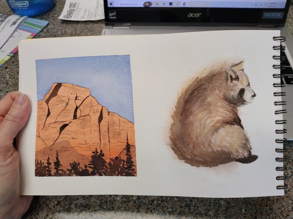 Red mountain cliffs painted in watercolor.
Bear painted in watercolor.