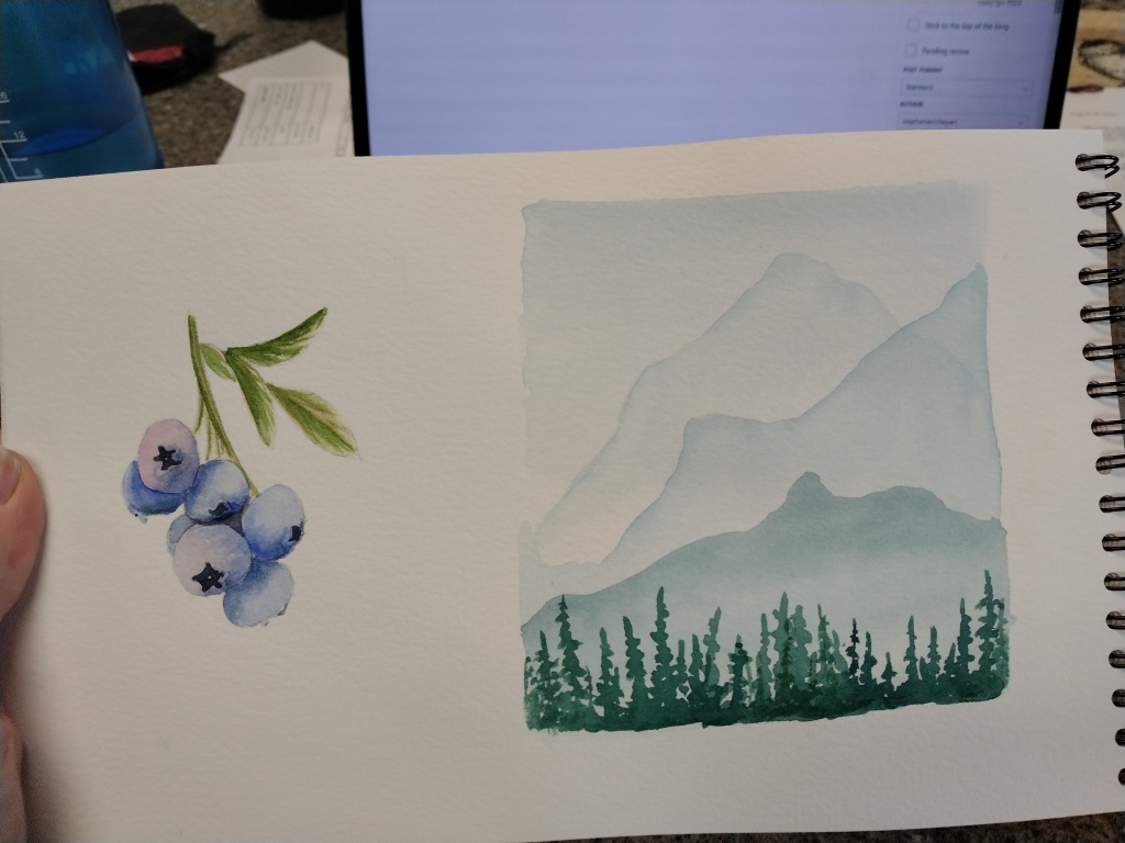 Cluster of blueberries painted in watercolor. 
Mountains in the distance painted in watercolor.