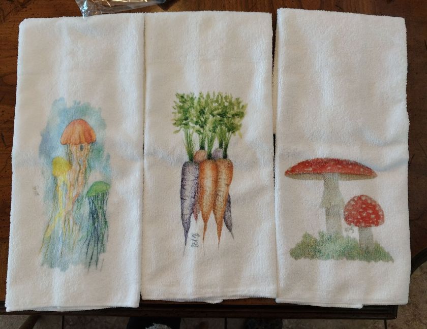 Microfiber towels.  Three different pictures sublimated on each one - a set of 3 jelly fish, Bunch of carrots, mushrooms with red caps.